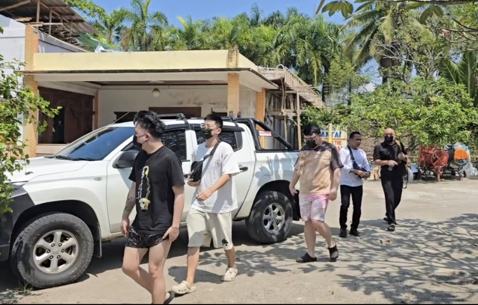 Immigration officers escort foreign nationals following a raid on a suspected cybercrime operation in Cimaja, Sukabumi, on April 14, 2026. (Beritasatu.com/Riza).