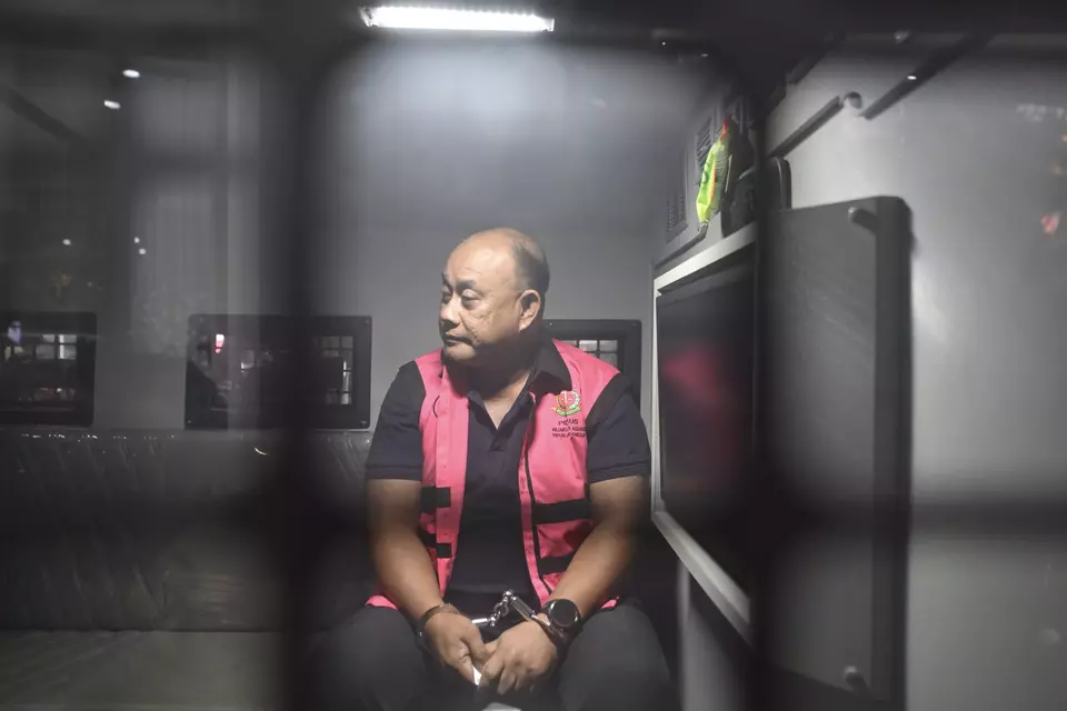 Former National Nutrition Agency (BGN) head Dadan Hindaya sits inside the detainee vehicle at the Attorney General's Office in Jakarta after he was named a corruption suspect on Wednesday, June 3, 2026. (Antara Photo/M Risyal Hidayat)