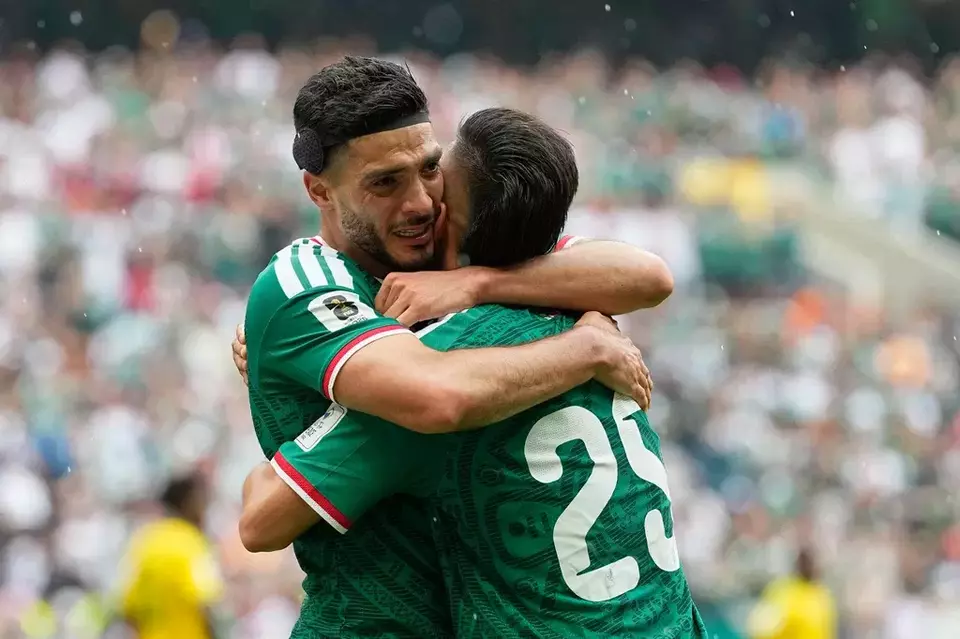 Mexico's Raul Jimenez hugs teammate Roberto Alvarado, right, after scoring his side's second goal during the World Cup Group A soccer match between Mexico and South Africa in Mexico City, Thursday, June 11, 2026. (AP Photo/Natacha Pisarenko)