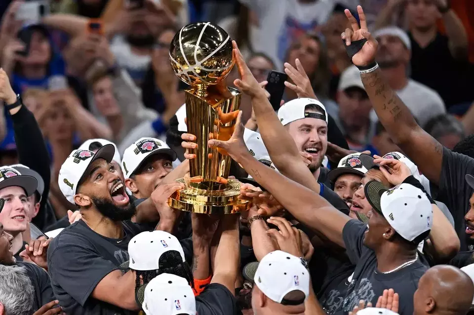 The New York Knicks celebrate with the Larry O'Brien Championship Trophy after defeating the San Antonio Spurs in Game 5 of the NBA Finals basketball series, Saturday, June 13, 2026, in San Antonio. (AP Photo/Darren Abate)